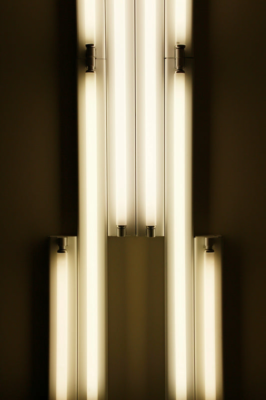 a wall with a bunch of lights hanging from it's sides