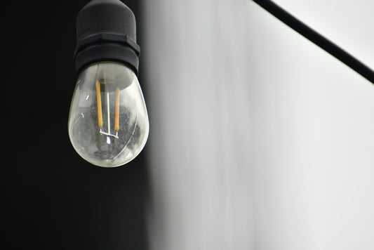 a light bulb hanging from the side of a wall
