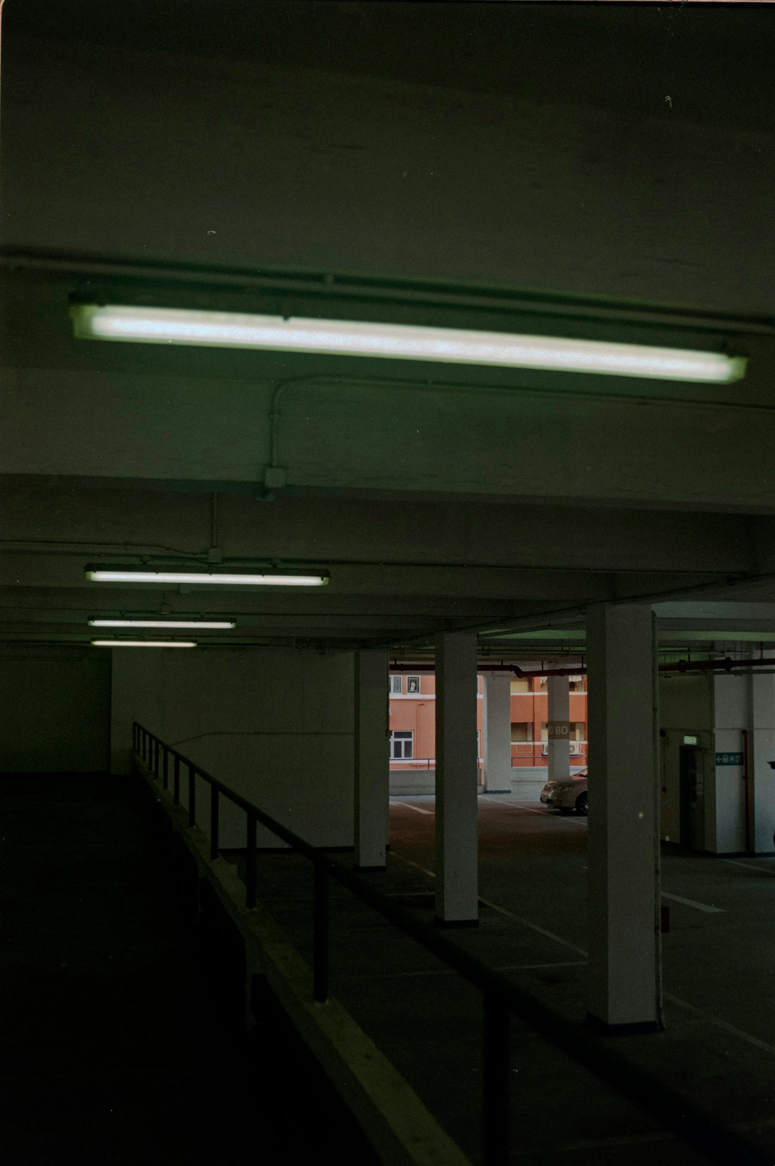 an empty parking garage with lights on the ceiling