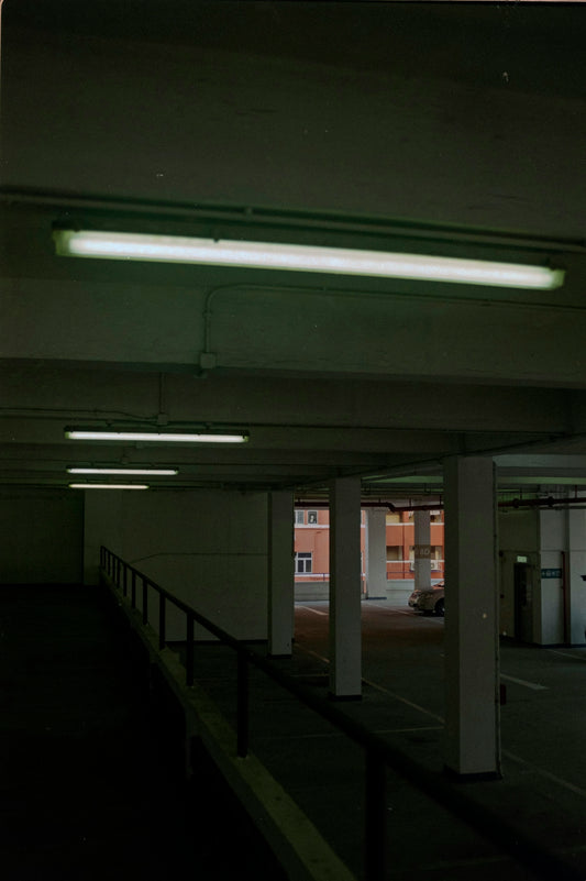 an empty parking garage with lights on the ceiling