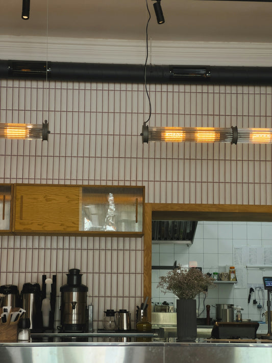 A kitchen with a lot of counter space and lights