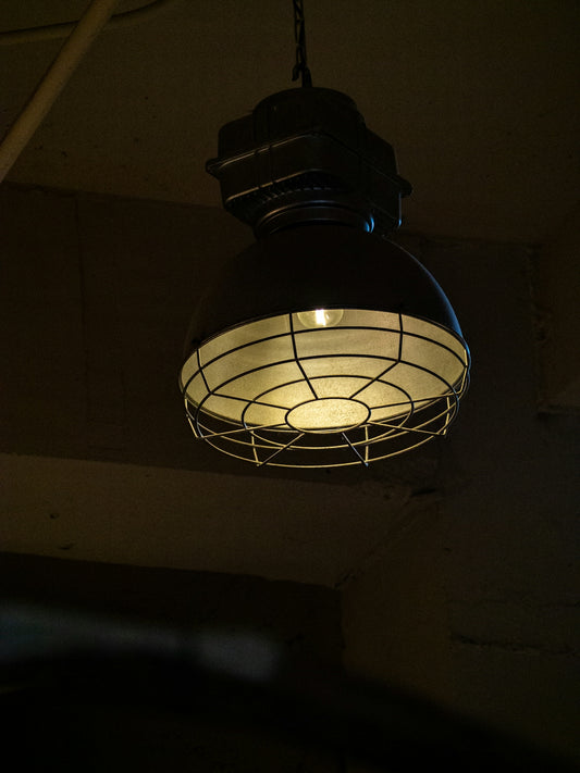 A light hanging from a ceiling in a dark room